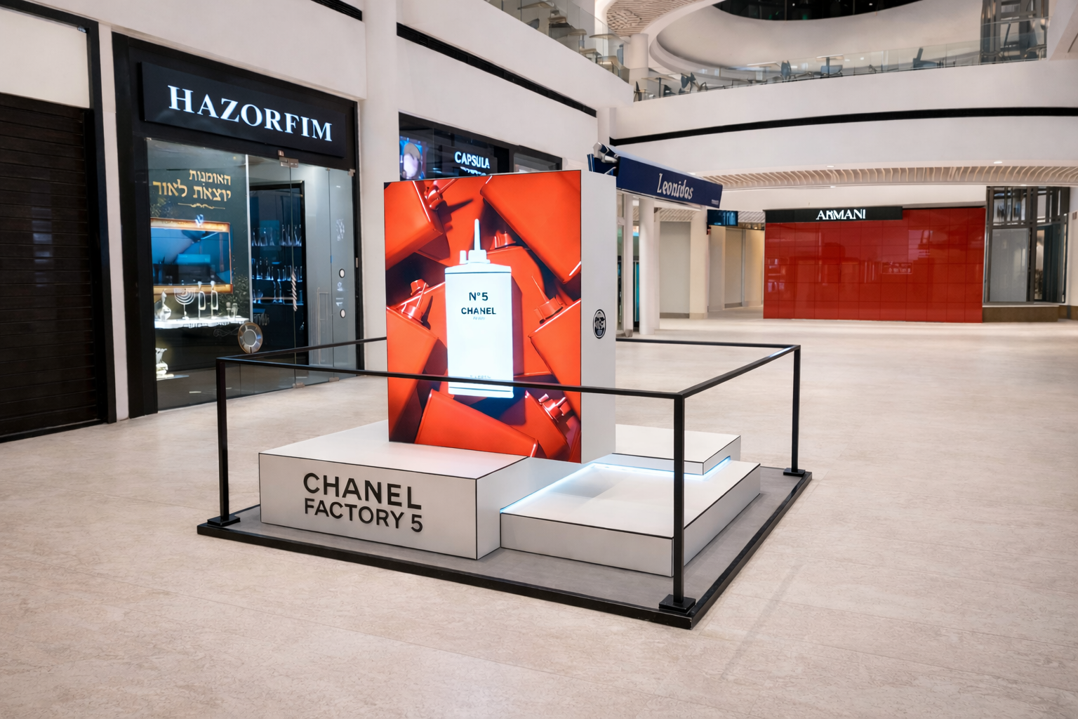 Freestanding fabric display unit in the mall for the Chanel brand.